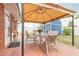 Covered patio area with seating for four, brick pavers, and access to backyard, storage shed at 2724 N Halifax Ave, Daytona Beach, FL 32118