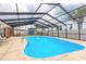 Enclosed pool area featuring a refreshing pool, patio space, and lush landscaping at 2724 N Halifax Ave, Daytona Beach, FL 32118