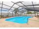 Inviting screened-in pool with lounge chairs, and surrounding greenery for a private oasis at 2724 N Halifax Ave, Daytona Beach, FL 32118