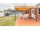 Backyard with pool, covered patio, and seating area, perfect for outdoor relaxation and entertaining at 2724 N Halifax Ave, Daytona Beach, FL 32118