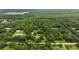Expansive aerial view of the property showcasing lush greenery, a pond, and a serene setting at 2950 Ragis Rd, Edgewater, FL 32132