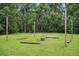 Large backyard featuring string lights and a firepit with custom wooden benches for entertaining at 2950 Ragis Rd, Edgewater, FL 32132