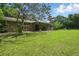 Large, expansive backyard with well maintained lawn and a covered patio is great for entertaining at 2950 Ragis Rd, Edgewater, FL 32132