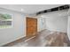 Finished basement with wood-look flooring, an AC unit, and a secure door with ample space at 2950 Ragis Rd, Edgewater, FL 32132