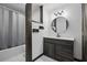 This bathroom boasts updated fixtures, modern farmhouse styling, a tub, and a dark vanity cabinet at 2950 Ragis Rd, Edgewater, FL 32132