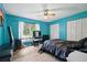 Bright blue bedroom with a large window for lots of natural light and modern light fixtures at 2950 Ragis Rd, Edgewater, FL 32132