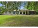 Charming single-story brick home featuring blue shutters and a lush green lawn at 2950 Ragis Rd, Edgewater, FL 32132