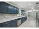 Updated kitchen with stainless steel dishwasher, sink, and gray backsplash at 2950 Ragis Rd, Edgewater, FL 32132