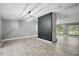 Open-concept living room with modern lighting, wood-look tile floors and natural light at 2950 Ragis Rd, Edgewater, FL 32132