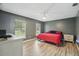 Main bedroom with warm wood floors, neutral walls, and backyard views at 2950 Ragis Rd, Edgewater, FL 32132