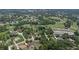 Expansive aerial view highlighting the neighborhood, golf course, and nearby amenities, a thriving community at 3 Pine Meadow Ct, Debary, FL 32713