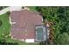 Aerial view showcases a beautiful pool, roof, and luscious landscaping at 3 Pine Meadow Ct, Debary, FL 32713