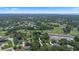 Scenic aerial view showcasing a residential area and golf course nestled among lush greenery and trees at 3 Pine Meadow Ct, Debary, FL 32713