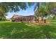 Expansive backyard featuring a screened pool and lush landscaping, ideal for outdoor living and entertaining at 3 Pine Meadow Ct, Debary, FL 32713