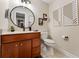 Modern bathroom with stylish vanity, decorative mirror, and a tiled floor at 3 Pine Meadow Ct, Debary, FL 32713