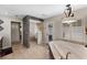A bright bathroom featuring a soaking tub, glass-enclosed shower, and a door to the outdoor patio at 3 Pine Meadow Ct, Debary, FL 32713