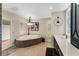 Light and airy bathroom with large garden tub, white quartz countertops, and shuttered windows at 3 Pine Meadow Ct, Debary, FL 32713