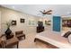Inviting bedroom with sitting area, ceiling fan, and window with plantation shutters at 3 Pine Meadow Ct, Debary, FL 32713