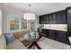 Cozy breakfast nook with banquette seating, glass table, and custom cabinetry at 3 Pine Meadow Ct, Debary, FL 32713