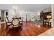 Open-concept dining and living room featuring hardwood floors at 3 Pine Meadow Ct, Debary, FL 32713