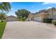 Spacious home featuring two garages and a large driveway, perfect for ample parking and storage at 3 Pine Meadow Ct, Debary, FL 32713