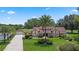 Beautiful home featuring manicured lawns, a large palm tree, a detached garage, and lush landscaping at 3 Pine Meadow Ct, Debary, FL 32713