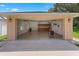 Open garage with epoxy flooring, built-in cabinets, and a spacious layout for parking and projects at 3 Pine Meadow Ct, Debary, FL 32713