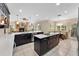 Open kitchen with dark cabinetry, a brick fireplace, an island, and tile flooring at 3 Pine Meadow Ct, Debary, FL 32713