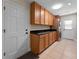 Functional laundry room with full-size washer and dryer, tile floor and ample storage at 3 Pine Meadow Ct, Debary, FL 32713