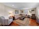 Spacious living room with hardwood floors, comfortable sectional, and a large area rug at 3 Pine Meadow Ct, Debary, FL 32713