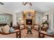Comfortable living room featuring a brick fireplace, ceiling fan, and hardwood floors at 3 Pine Meadow Ct, Debary, FL 32713