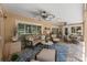Comfortable covered patio with ceiling fans, stylish seating and decor, creating an inviting outdoor living space at 3 Pine Meadow Ct, Debary, FL 32713