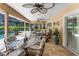 Comfortable covered patio featuring elegant furniture, ceiling fans, and views of the lush backyard and pool at 3 Pine Meadow Ct, Debary, FL 32713