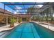 Relaxing screened-in pool with a spa, offering a private and refreshing outdoor oasis with lush green surroundings at 3 Pine Meadow Ct, Debary, FL 32713