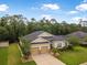 Aerial view of the home features a well-manicured yard, neutral paint, and a two-car garage at 31 Abacus Ave, Ormond Beach, FL 32174