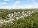 Overhead shot showcases a residential neighborhood surrounded by dense forest and a winding lake at 31 Abacus Ave, Ormond Beach, FL 32174