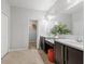 Bright bathroom with double sinks, vanity area, and a glimpse into the walk-in closet at 31 Abacus Ave, Ormond Beach, FL 32174