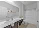 Well-lit bathroom featuring a sleek vanity, framed mirror, and a bathtub with shower at 31 Abacus Ave, Ormond Beach, FL 32174
