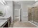 Primary bathroom featuring dual sinks, vanity, walk-in shower, and neutral tile floors at 31 Abacus Ave, Ormond Beach, FL 32174