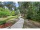 A winding sidewalk surrounded by nature leading to the community clubhouse at 31 Abacus Ave, Ormond Beach, FL 32174