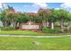 The community entrance sign adorned with flowering trees and well-manicured landscaping at 31 Abacus Ave, Ormond Beach, FL 32174