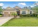 Well-maintained single-story home featuring a manicured lawn and attractive landscaping at 31 Abacus Ave, Ormond Beach, FL 32174