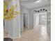 Open hallway with neutral color palette and unique decorative artwork on the wall at 31 Abacus Ave, Ormond Beach, FL 32174