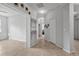 Hallway features neutral tile flooring, decorative art, and access to the living spaces at 31 Abacus Ave, Ormond Beach, FL 32174