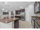 Spacious kitchen featuring dark wood cabinets, stainless steel appliances, and stylish pendant lighting at 31 Abacus Ave, Ormond Beach, FL 32174