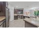 Modern kitchen with dark cabinets, granite countertops, stainless steel appliances and tile flooring at 31 Abacus Ave, Ormond Beach, FL 32174
