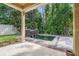 An elegant patio with a beautiful koi pond and lovely waterfall feature surrounded by lush landscaping at 31 Abacus Ave, Ormond Beach, FL 32174