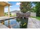 Relaxing backyard pond with a waterfall feature and beautiful, colorful Koi fish at 31 Abacus Ave, Ormond Beach, FL 32174