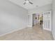 Bright and airy living room featuring french doors and open access to another room with chandelier at 31 Abacus Ave, Ormond Beach, FL 32174