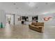 Open concept living room showcasing kitchen, tile floors, and modern chandeliers providing a light and airy atmosphere at 31 Abacus Ave, Ormond Beach, FL 32174